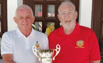 The image shows Alan Campbell, Club President (Red), presenting the trophy to Club Captain Dave Greenland (White)